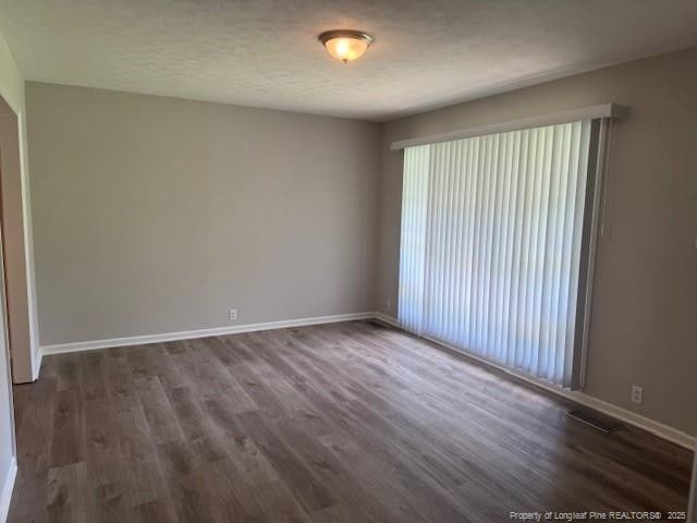 5027 Chesapeake Rd, Fayetteville, NC 28311 - unfurnished room with dark wood-style flooring