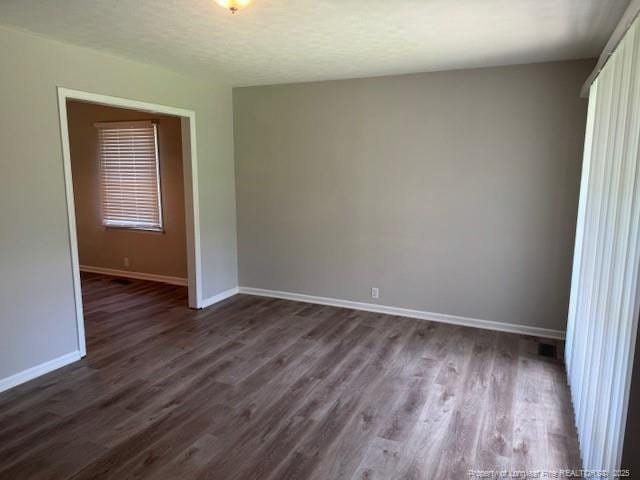 5027 Chesapeake Rd, Fayetteville, NC 28311 - unfurnished room featuring dark wood-style floors and baseboards