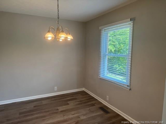 5027 Chesapeake Rd, Fayetteville, NC 28311 - unfurnished room featuring healthy amount of natural light, dark wood finished floors, and a chandelier