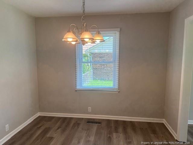 5027 Chesapeake Rd, Fayetteville, NC 28311 - unfurnished dining area featuring dark wood-type flooring and a chandelier