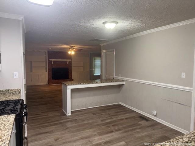 5027 Chesapeake Rd, Fayetteville, NC 28311 - kitchen with gas stove, dark wood-type flooring, crown molding, a textured ceiling, and ceiling fan