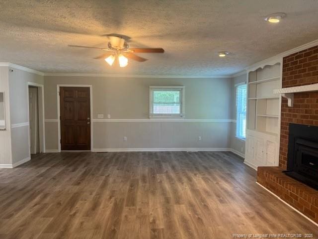 5027 Chesapeake Rd, Fayetteville, NC 28311 - unfurnished living room featuring a textured ceiling, ornamental molding, ceiling fan, wood finished floors, and a fireplace