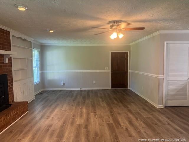 5027 Chesapeake Rd, Fayetteville, NC 28311 - unfurnished living room featuring ornamental molding, a textured ceiling, ceiling fan, wood finished floors, and a fireplace