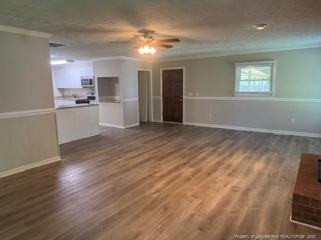 5027 Chesapeake Rd, Fayetteville, NC 28311 - unfurnished living room featuring a ceiling fan, ornamental molding, dark wood-style floors, a textured ceiling, and a wainscoted wall