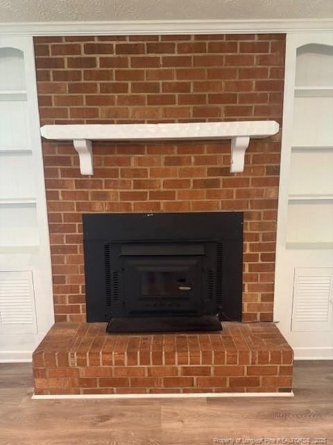 5027 Chesapeake Rd, Fayetteville, NC 28311 - detailed view of a fireplace and wood finished floors