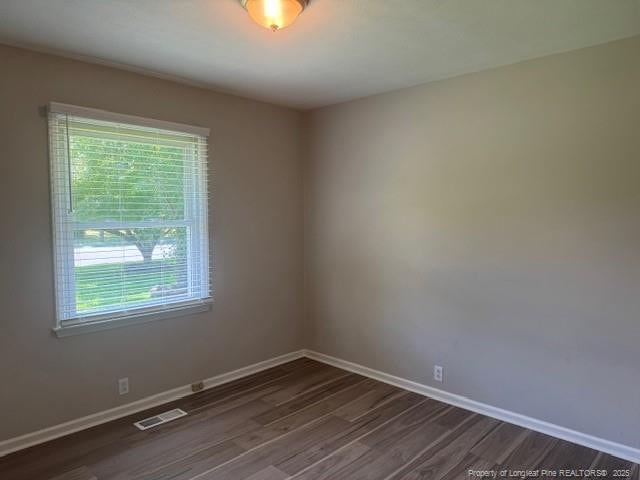 5027 Chesapeake Rd, Fayetteville, NC 28311 - spare room with baseboards and dark wood-style floors