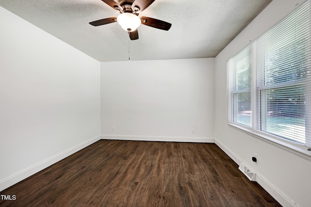 8905 Dukes Lake Rd, Zebulon, NC 27597 - empty room with a textured ceiling, dark wood-style floors, and ceiling fan
