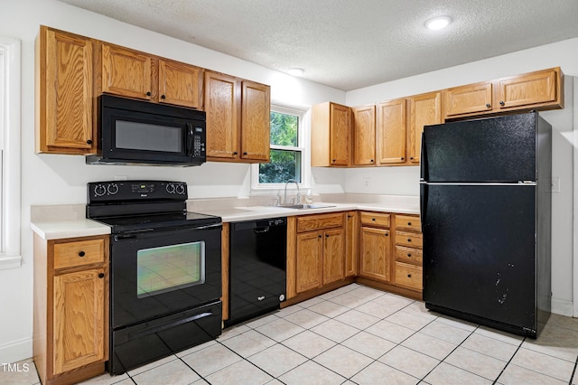 8905 Dukes Lake Rd, Zebulon, NC 27597 - kitchen featuring black appliances, a textured ceiling, light countertops, and light tile patterned flooring