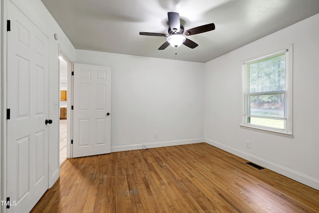 8905 Dukes Lake Rd, Zebulon, NC 27597 - unfurnished bedroom featuring wood-type flooring and a ceiling fan