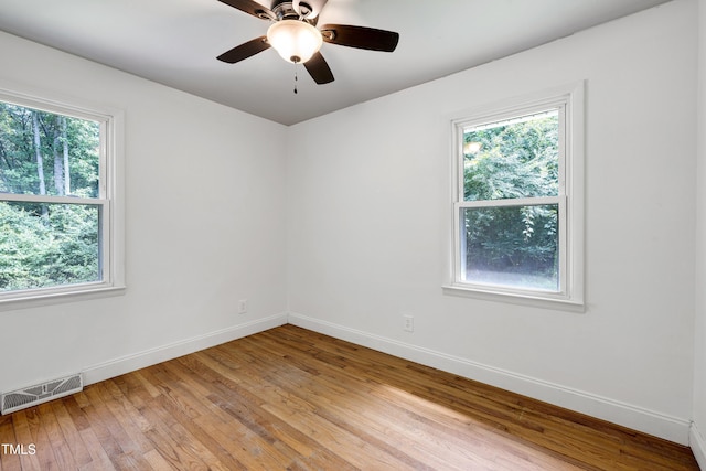 8905 Dukes Lake Rd, Zebulon, NC 27597 - unfurnished room featuring healthy amount of natural light, light wood-style flooring, and ceiling fan