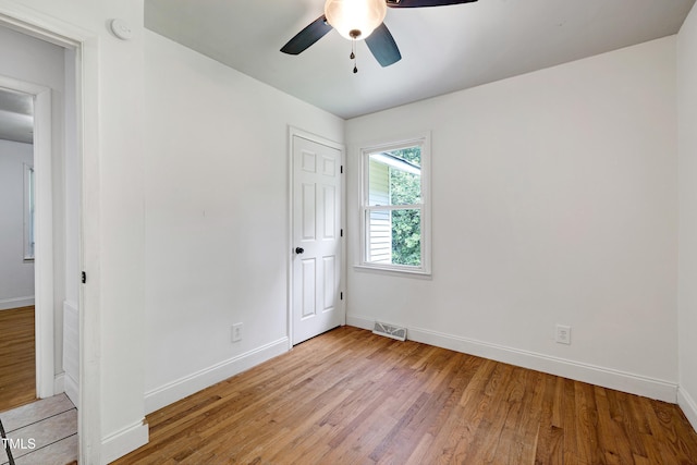 8905 Dukes Lake Rd, Zebulon, NC 27597 - unfurnished bedroom with light wood finished floors and a ceiling fan