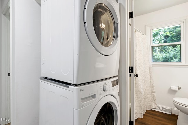 8905 Dukes Lake Rd, Zebulon, NC 27597 - laundry room featuring stacked washer / drying machine and dark wood finished floors