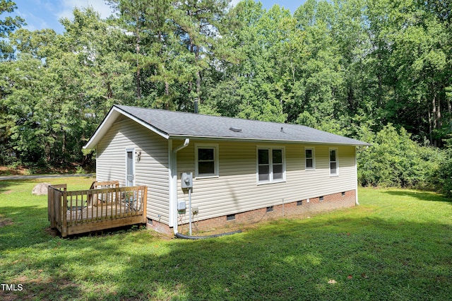 8905 Dukes Lake Rd, Zebulon, NC 27597 - view of home's exterior featuring crawl space, a lawn, a wooden deck, and roof with shingles