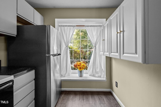 116 Saint Andrews Ln, Chapel Hill, NC 27517 - kitchen featuring white cabinetry, wood finished floors, and freestanding refrigerator