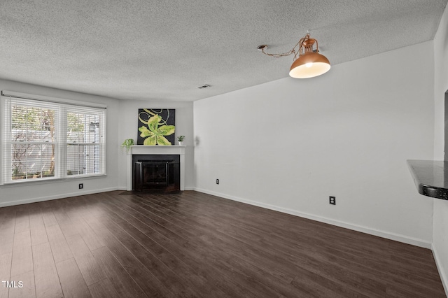 116 Saint Andrews Ln, Chapel Hill, NC 27517 - unfurnished living room with a fireplace with flush hearth, a textured ceiling, and dark wood finished floors
