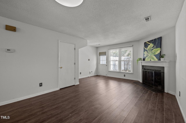 116 Saint Andrews Ln, Chapel Hill, NC 27517 - unfurnished living room featuring a fireplace with flush hearth, dark wood-style floors, and a textured ceiling