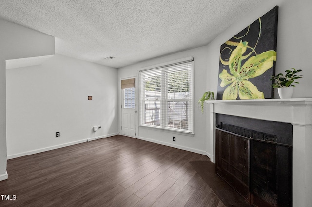 116 Saint Andrews Ln, Chapel Hill, NC 27517 - unfurnished living room featuring a fireplace with flush hearth, a textured ceiling, and wood finished floors