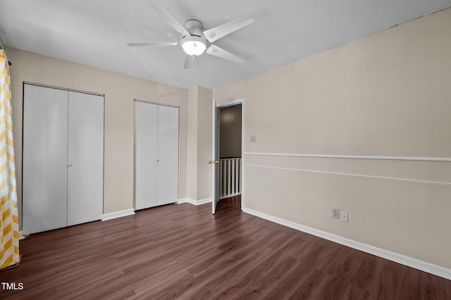 116 Saint Andrews Ln, Chapel Hill, NC 27517 - unfurnished bedroom with multiple closets, wood finished floors, and a ceiling fan