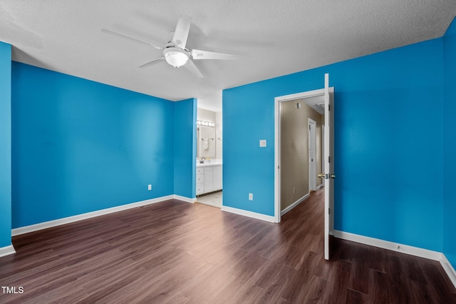 116 Saint Andrews Ln, Chapel Hill, NC 27517 - unfurnished bedroom with wood finished floors, a textured ceiling, a ceiling fan, and ensuite bath