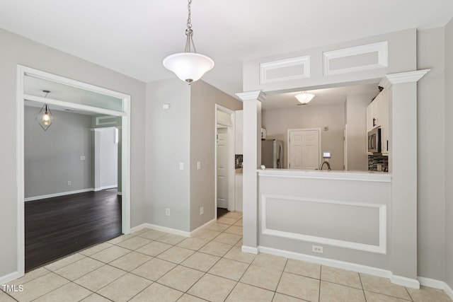 1212 Southgate Dr, Raleigh, NC 27610 - unfurnished dining area with light tile patterned floors and baseboards