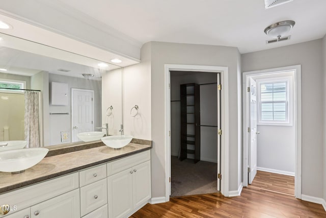 1212 Southgate Dr, Raleigh, NC 27610 - bathroom with wood finished floors, double vanity, and a shower with shower curtain
