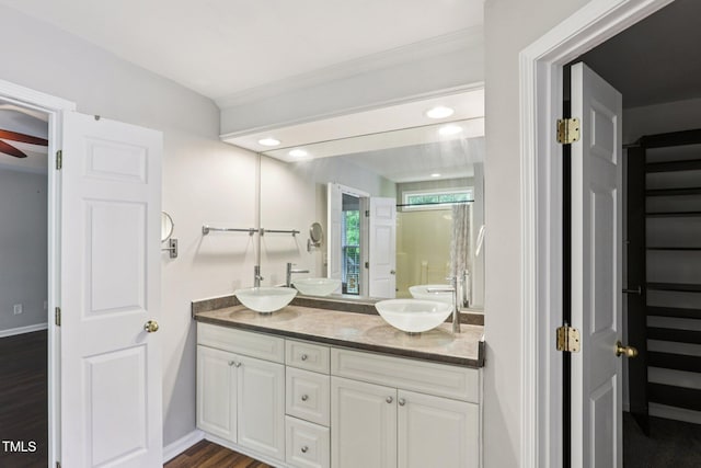 1212 Southgate Dr, Raleigh, NC 27610 - bathroom with double vanity, wood finished floors, recessed lighting, a ceiling fan, and a shower with shower door