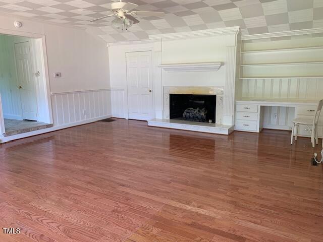 1003 Summerville Mamers Rd, Lillington, NC 27546 - unfurnished living room featuring ceiling fan, wood finished floors, and a fireplace with raised hearth