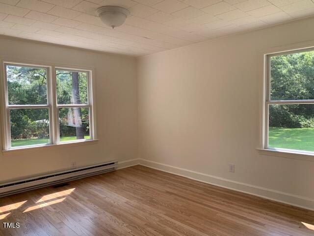 1003 Summerville Mamers Rd, Lillington, NC 27546 - unfurnished room featuring a baseboard heating unit and wood finished floors