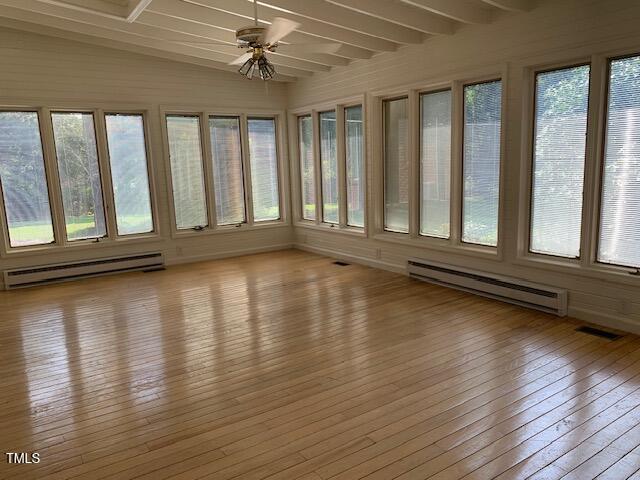 1003 Summerville Mamers Rd, Lillington, NC 27546 - unfurnished sunroom with a baseboard radiator, wood-type flooring, plenty of natural light, and beam ceiling