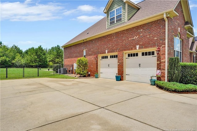 2825 Sand Trap Ln, Hope Mills, NC 28348 - view of side of home with brick siding, concrete driveway, and a garage