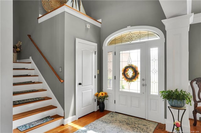 2825 Sand Trap Ln, Hope Mills, NC 28348 - entryway featuring wood finished floors, stairs, high vaulted ceiling, and ornate columns