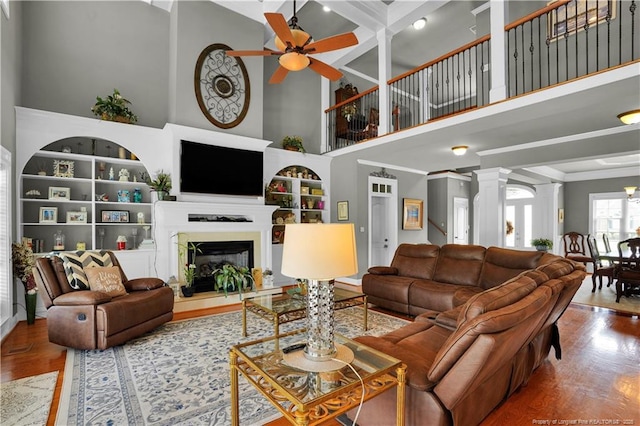 2825 Sand Trap Ln, Hope Mills, NC 28348 - living room with a ceiling fan, decorative columns, wood finished floors, a high ceiling, and built in features