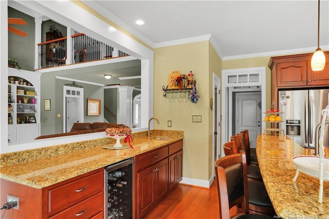 2825 Sand Trap Ln, Hope Mills, NC 28348 - kitchen with stainless steel refrigerator with ice dispenser, beverage cooler, light stone counters, light wood-style floors, and crown molding