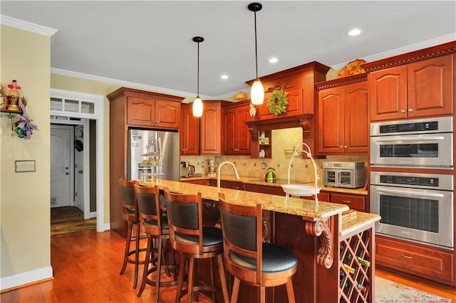 2825 Sand Trap Ln, Hope Mills, NC 28348 - kitchen with appliances with stainless steel finishes, dark wood-type flooring, crown molding, tasteful backsplash, and pendant lighting
