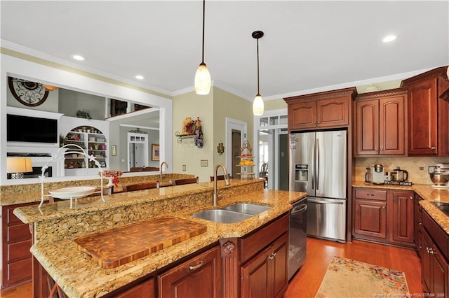 2825 Sand Trap Ln, Hope Mills, NC 28348 - kitchen featuring stainless steel refrigerator with ice dispenser, crown molding, light wood-style floors, a center island with sink, and light stone counters