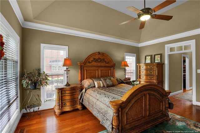 2825 Sand Trap Ln, Hope Mills, NC 28348 - bedroom with wood finished floors, a ceiling fan, a raised ceiling, and crown molding