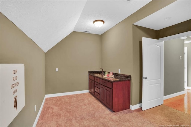 2825 Sand Trap Ln, Hope Mills, NC 28348 - bar area with light colored carpet, vaulted ceiling, and a textured ceiling