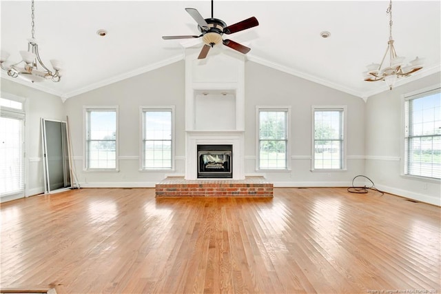 1190 Mckeller Rd, Fairmont, NC 28340 - unfurnished living room featuring a chandelier, light wood finished floors, vaulted ceiling, a brick fireplace, and ceiling fan
