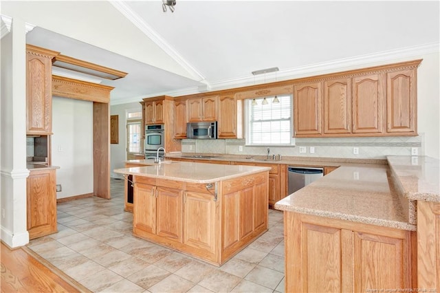 1190 Mckeller Rd, Fairmont, NC 28340 - kitchen with appliances with stainless steel finishes, lofted ceiling, crown molding, decorative backsplash, and a kitchen island with sink