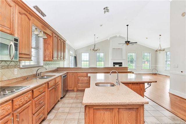 1190 Mckeller Rd, Fairmont, NC 28340 - kitchen featuring a chandelier, stainless steel appliances, ceiling fan, a fireplace, and lofted ceiling