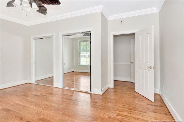 1190 Mckeller Rd, Fairmont, NC 28340 - unfurnished bedroom with ornamental molding, multiple closets, light wood finished floors, and a ceiling fan