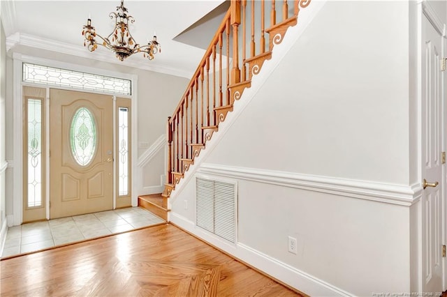 1190 Mckeller Rd, Fairmont, NC 28340 - foyer entrance featuring a chandelier, stairs, crown molding, and tile patterned floors