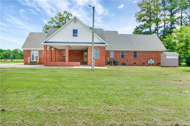 1190 Mckeller Rd, Fairmont, NC 28340 - back of property with a yard, a storage unit, and brick siding