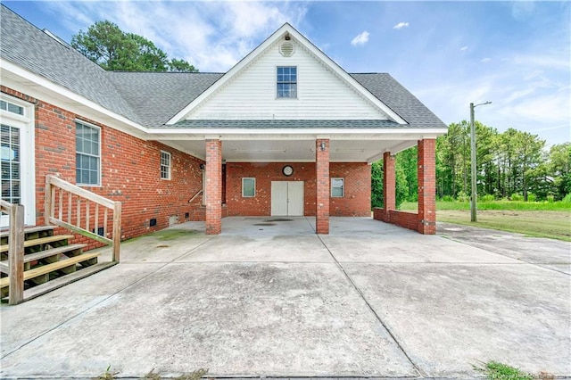 1190 Mckeller Rd, Fairmont, NC 28340 - view of front of home with brick siding, concrete driveway, an attached carport, and roof with shingles
