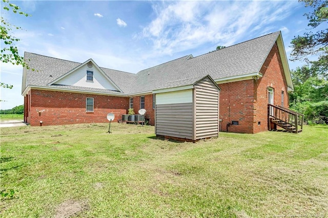 1190 Mckeller Rd, Fairmont, NC 28340 - rear view of house featuring brick siding, crawl space, a lawn, and a shingled roof