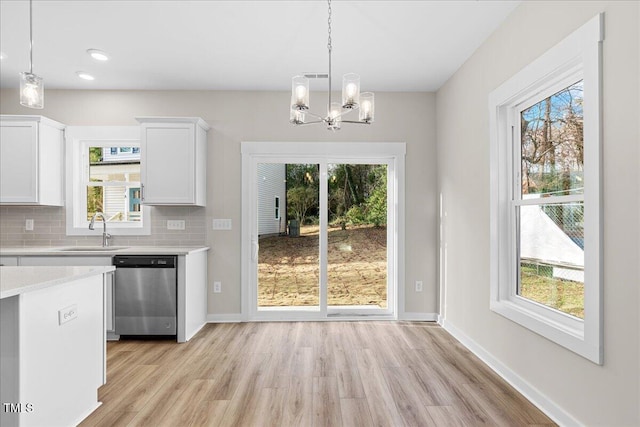 1917 Essex Unit B, Durham, NC 27704 - kitchen with dishwasher, light countertops, a chandelier, light wood-style flooring, and healthy amount of natural light