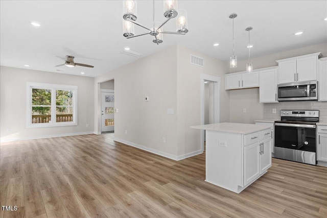 1917 Essex Unit B, Durham, NC 27704 - kitchen featuring stainless steel appliances, light wood-type flooring, light countertops, open floor plan, and recessed lighting
