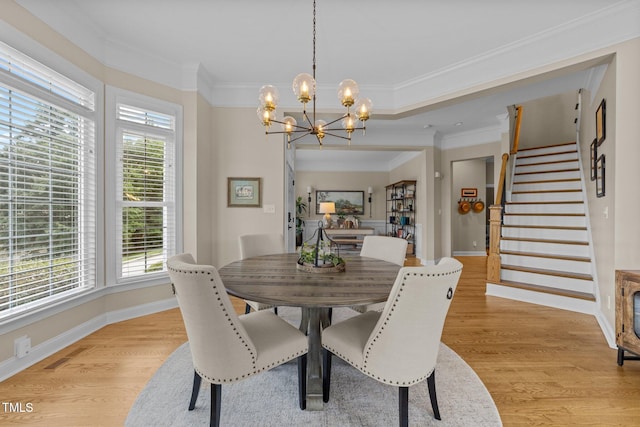 12510 Megan Hill Ct, Raleigh, NC 27614 - dining room featuring a chandelier, crown molding, stairs, and light wood-style floors