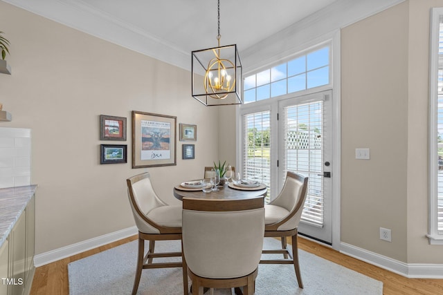 12510 Megan Hill Ct, Raleigh, NC 27614 - dining area featuring ornamental molding, a chandelier, and light wood-style flooring