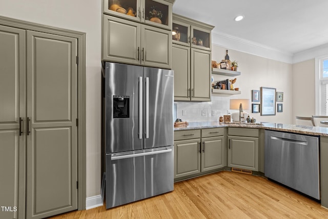 12510 Megan Hill Ct, Raleigh, NC 27614 - kitchen with stainless steel appliances, light wood-type flooring, gray cabinets, light stone counters, and ornamental molding